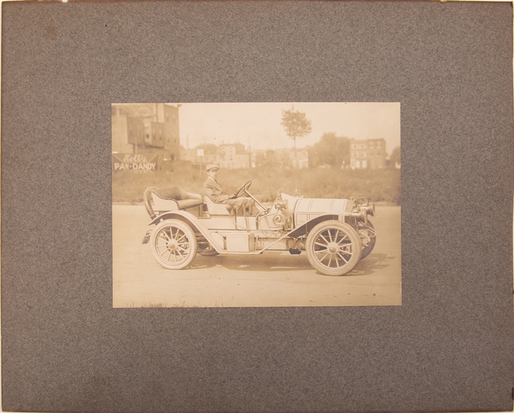 EARLY 20TH C. ALBUMEN PRINT OF A MAN IN AN AUTOMOBILE