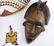20TH CENTURY AFRICAN MASKS, BEADED PURSE, & ZULU SHIELD