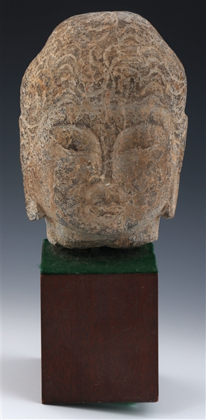 CARVED STONE BUDDHA HEAD ON WOODEN BASE 