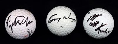 AUTOGRAPHED GOLF BALLS - WOODS, NORMAN, & KUCHAR 